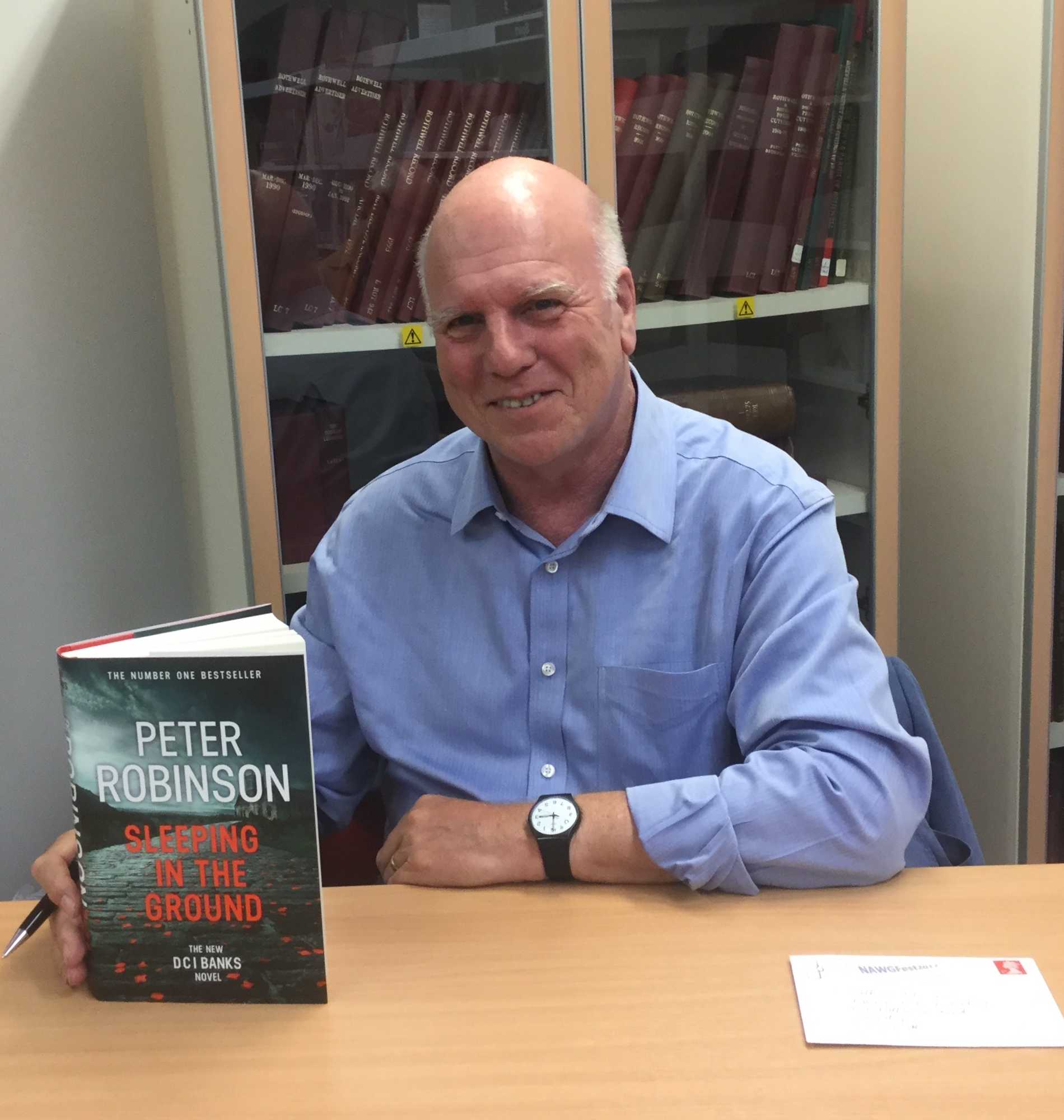 Image: Photograph of Peter Robinson presenting his book <em>Sleeping in the Ground</em>
